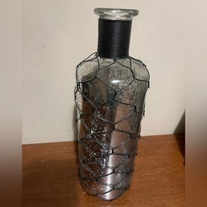 Silver bottle with black cord for decor